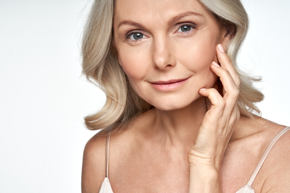 50s,Mid,Aged,Woman,Touching,Face,Skin,Looking,At,Camera. Dysport in Atlanta